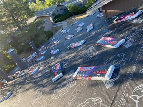 Roof covered with many scattered red, white, and blue signs or flyers, viewed from above