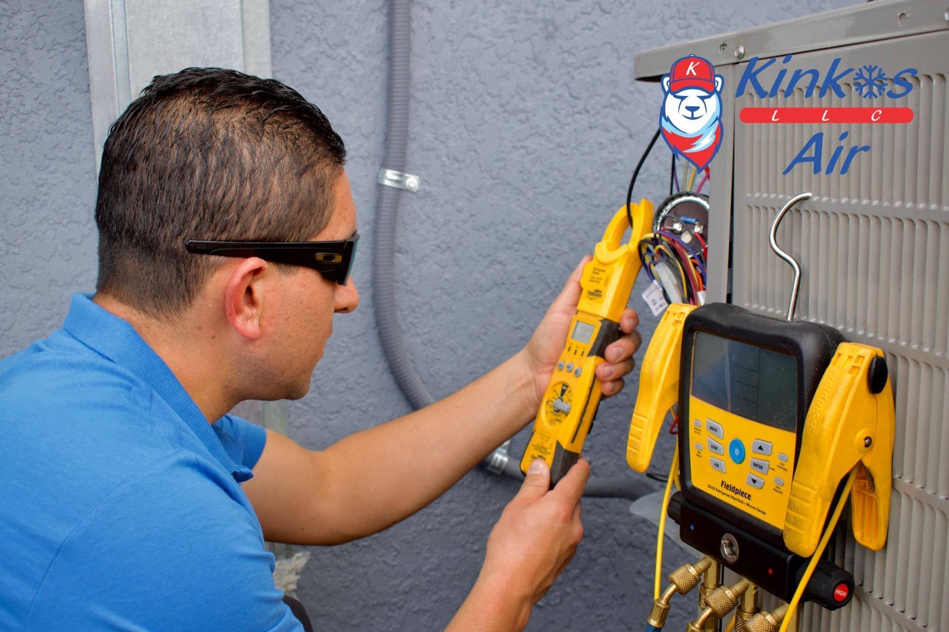 Technician using a yellow meter to inspect HVAC equipment mounted on a wall
