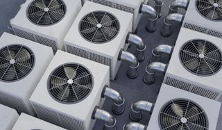 Rows of outdoor HVAC condenser units with visible fans and piping, viewed from above Rows of outdoor HVAC condenser units with visible fans and piping, viewed from above