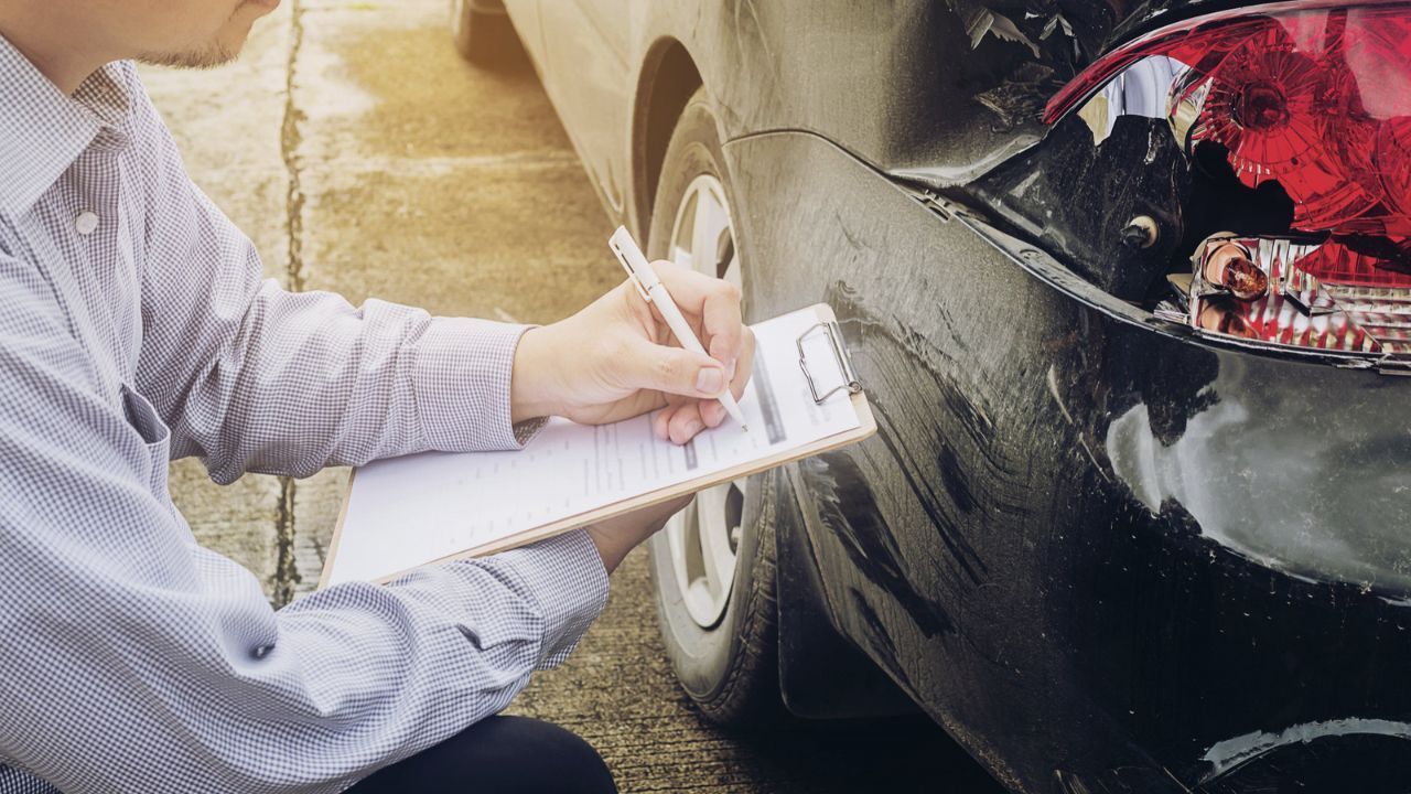 Man reviewing and tallying an auto repair bill to determine results and expenses
