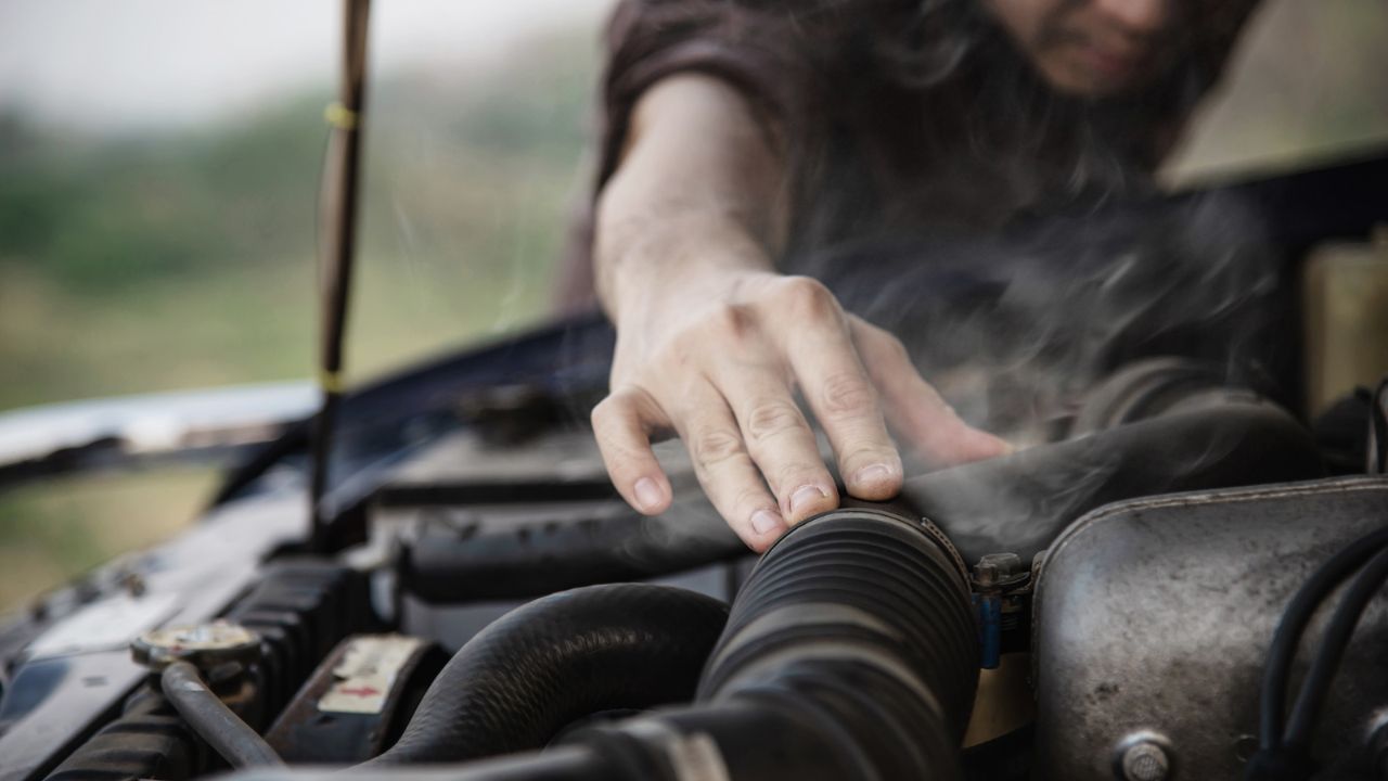 Smoke coming from car engine showing possible overheating problem