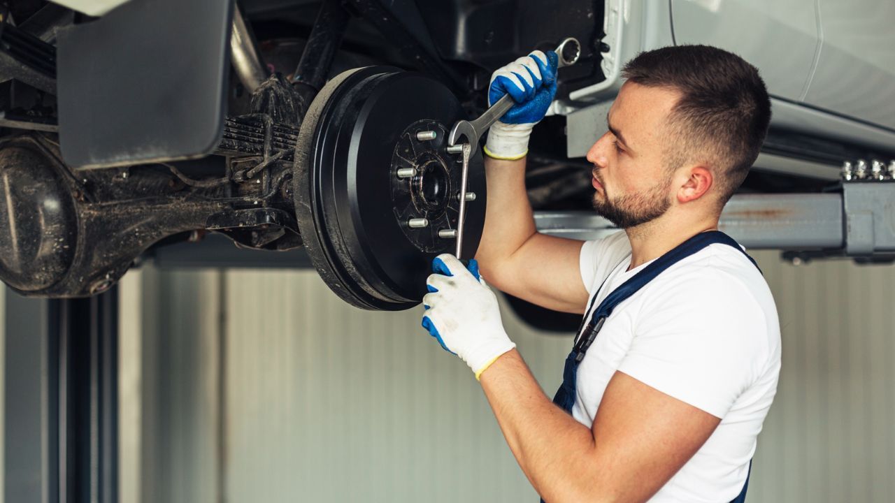 Professional technician replacing brake components during a vehicle brake repair service