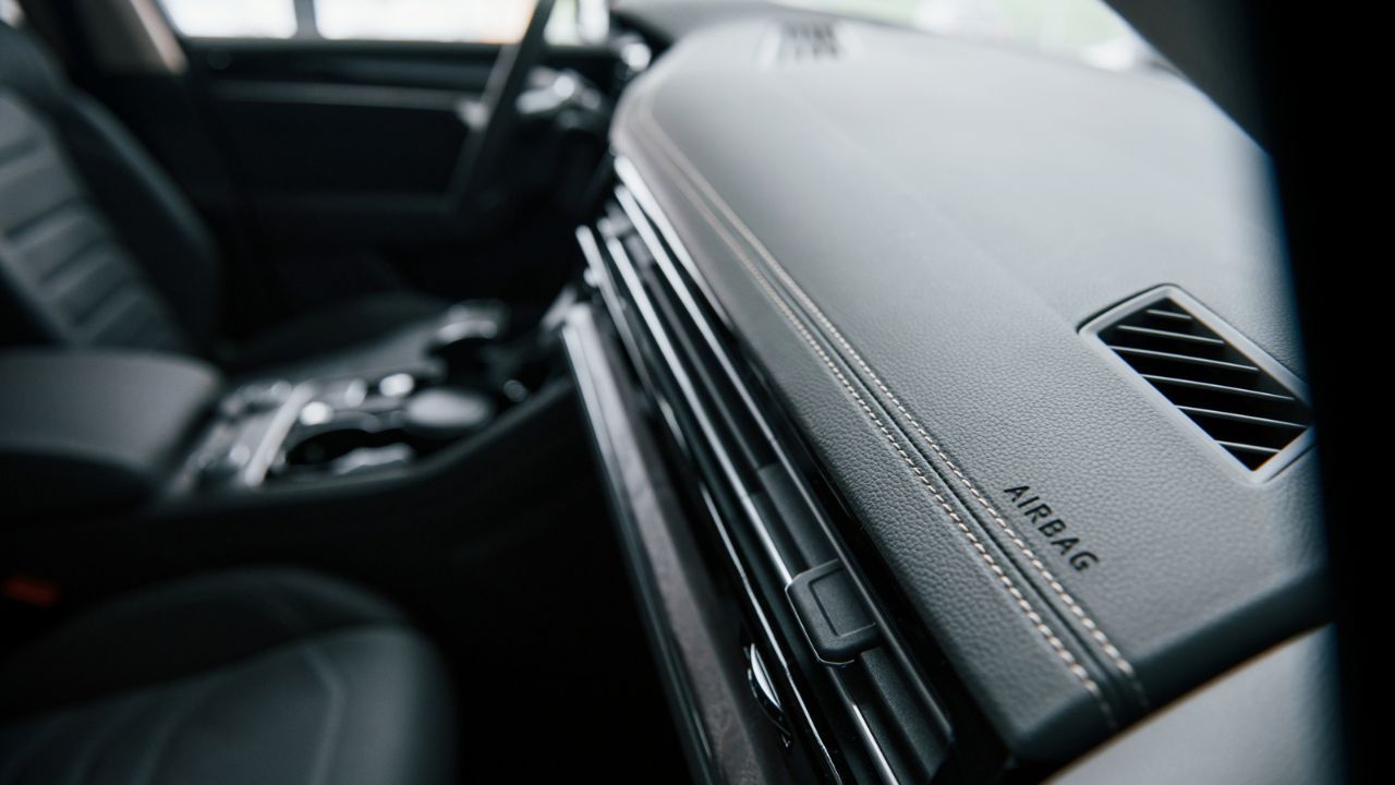 Modern car dashboard with airbag indicator and air vent
