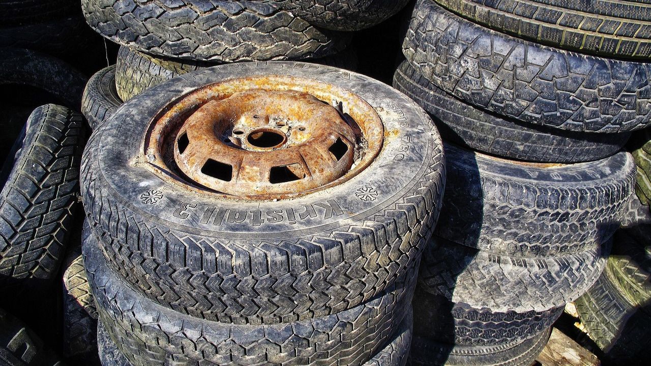 Stack of worn and damaged tires awaiting disposal or recycling