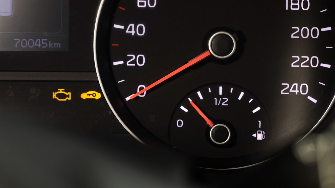  Vehicle dashboard displaying the check engine warning light, indicating a possible engine or emissions system problem.