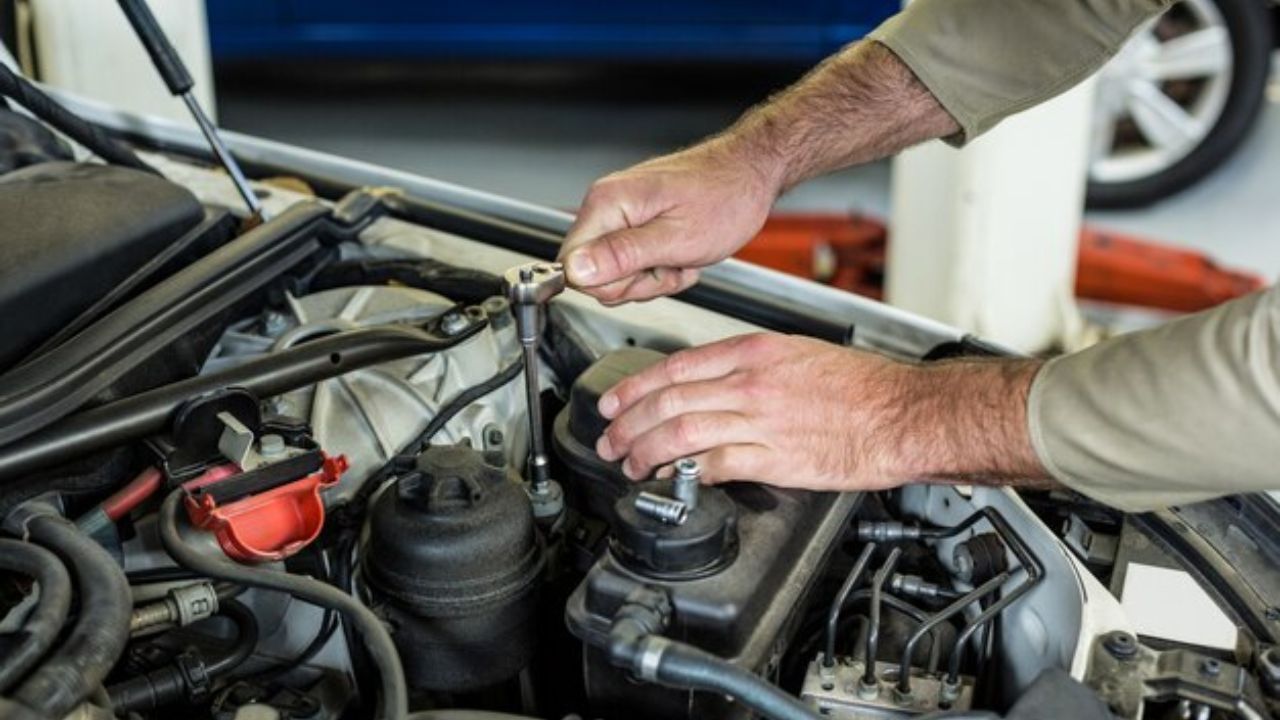 Auto mechanic inspecting a car engine