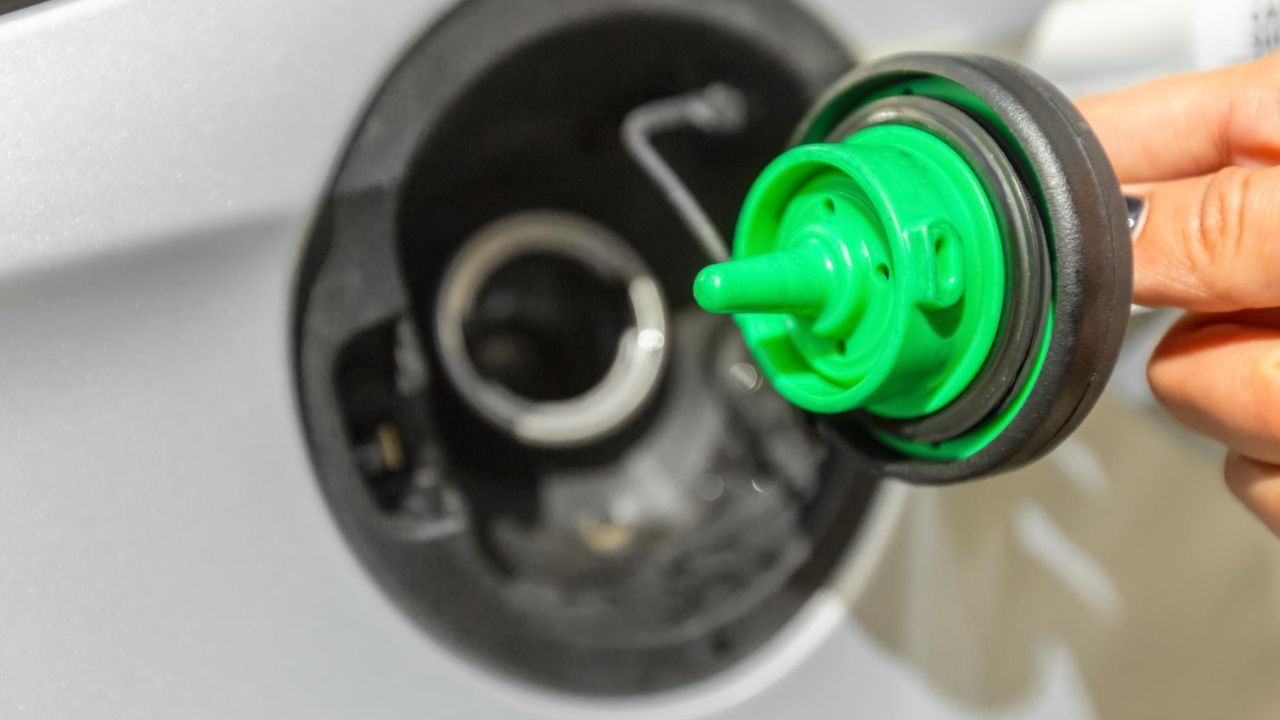 Close-up of a vehicle fuel cap removed during a fuel system inspection to check the gas cap seal and prevent EVAP system issues.
