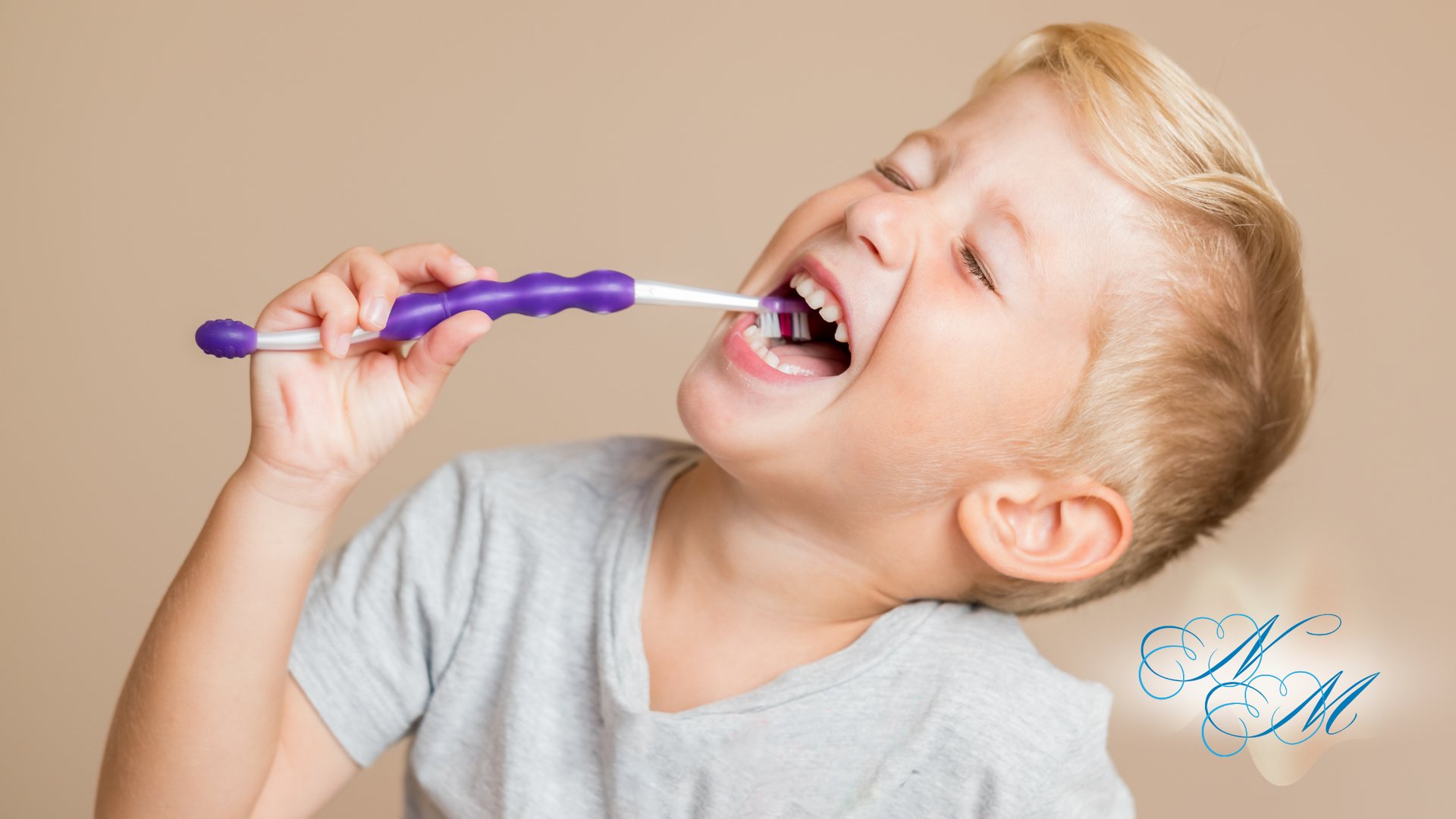 Boy brushing teeth with a purple toothbrush. He has his mouth wide open and his eyes closed.