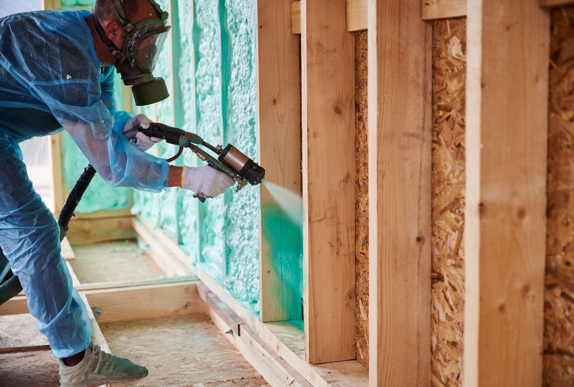 Residential insulation contractors fitting insulation in frame. Residential insulation contractor fitting insulation in frame.