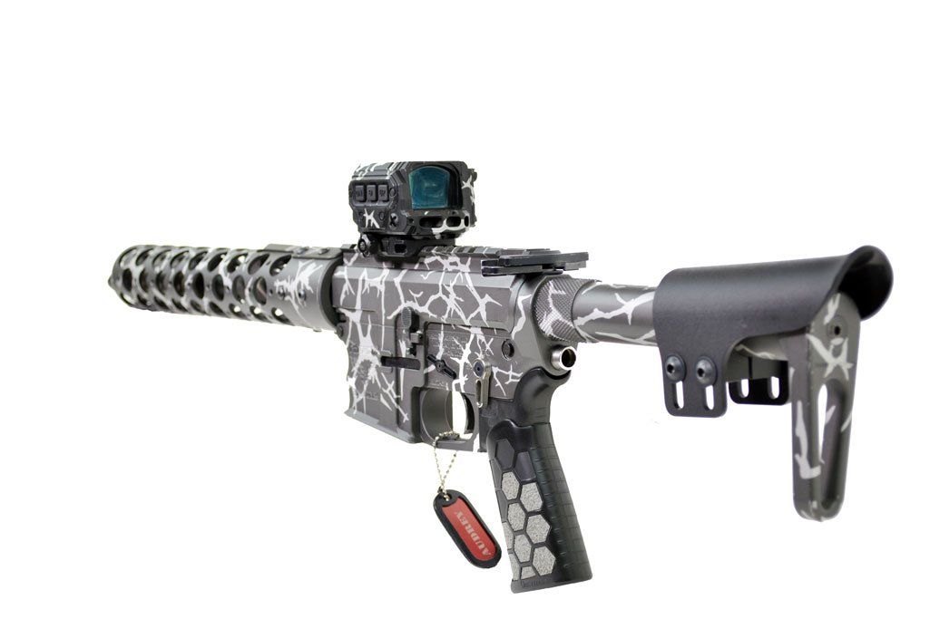 A customized rifle with a camo pattern, red dot sight, and a black stock.