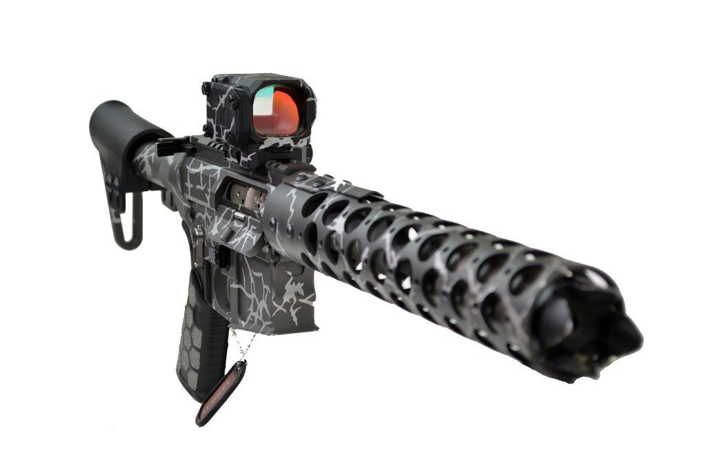 Assault rifle with camouflage, red dot sight, and a vented barrel.