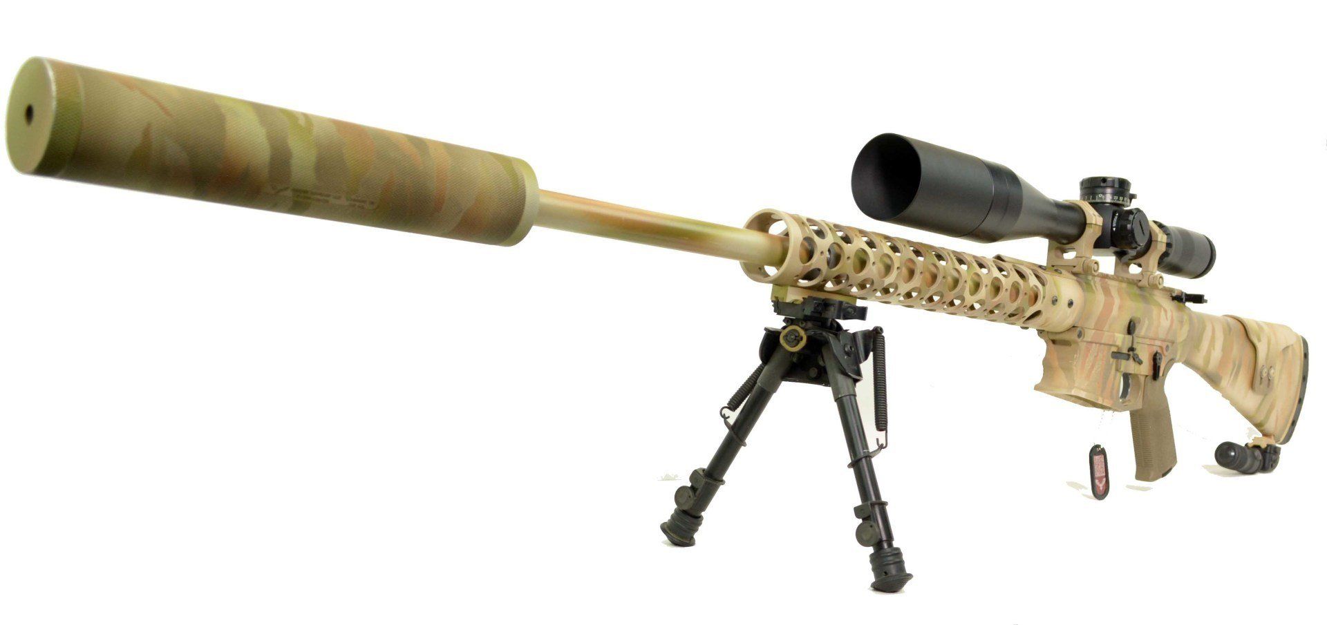 A sniper rifle with a large scope and silencer is resting on a bipod in a white setting.