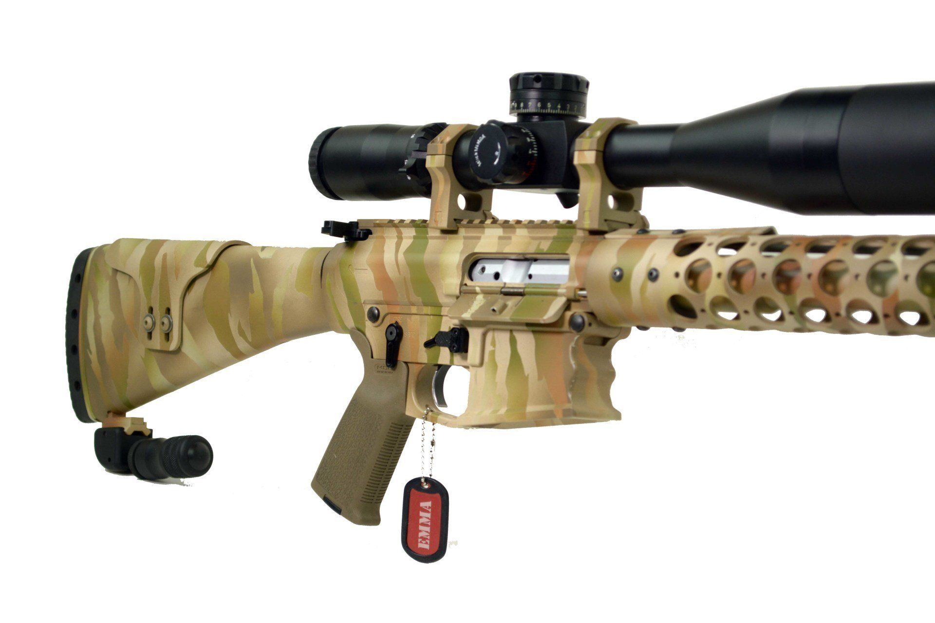 Camouflaged rifle with scope, a tag hangs from the trigger guard.