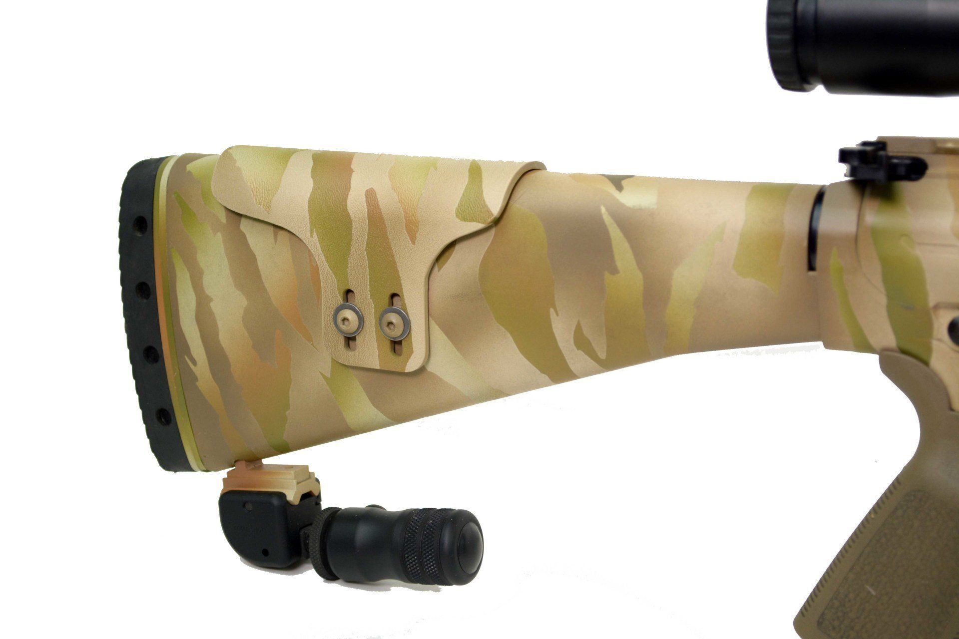 Camouflage stock of a rifle, with attached cheek rest and a black rubber pad.
