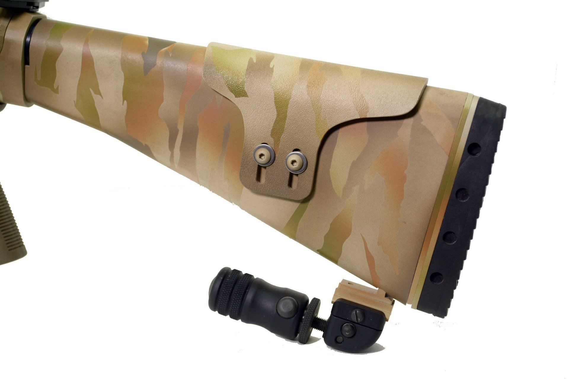 Tan and camo patterned rifle stock with adjustable cheek rest, detached bipod.