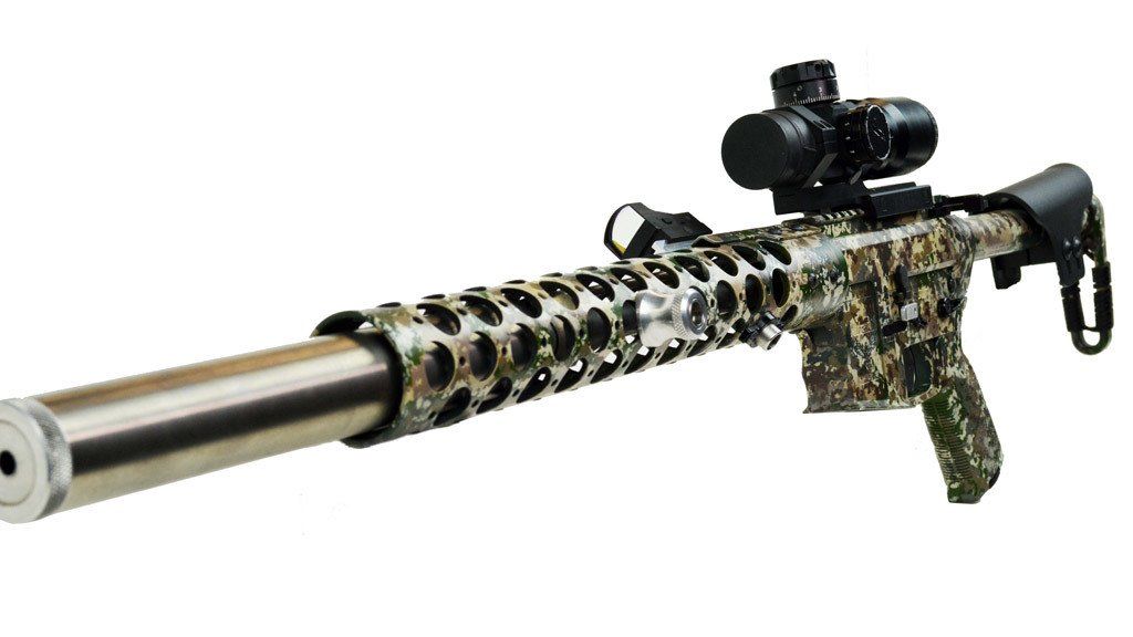 Camouflaged rifle with a scope and silencer.