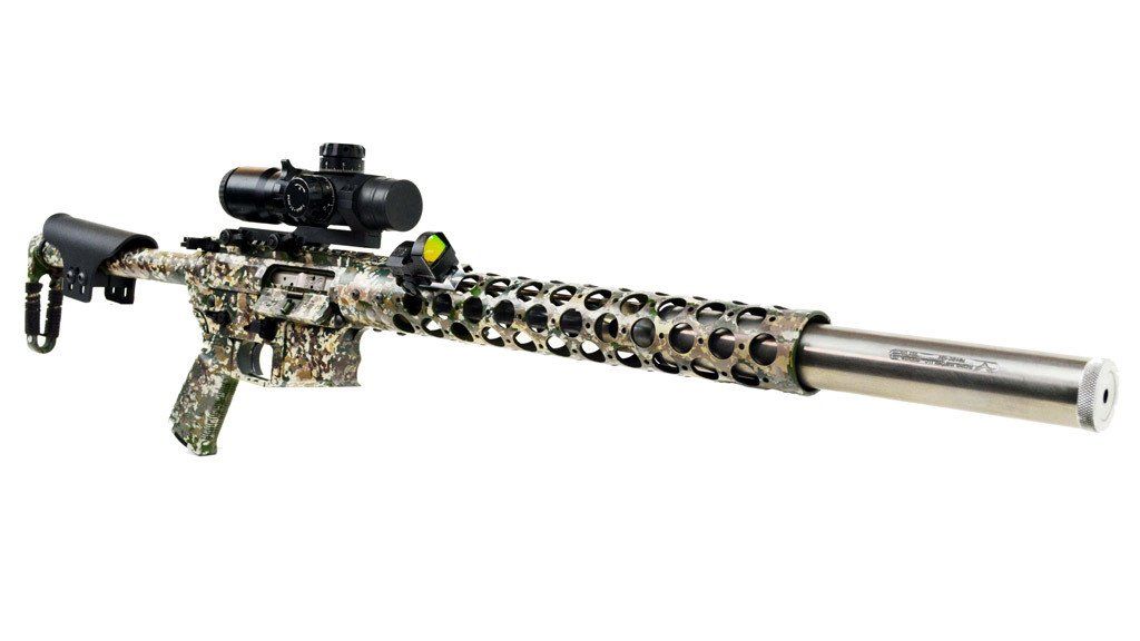 A camouflage rifle with a scope and suppressor, on a white background.