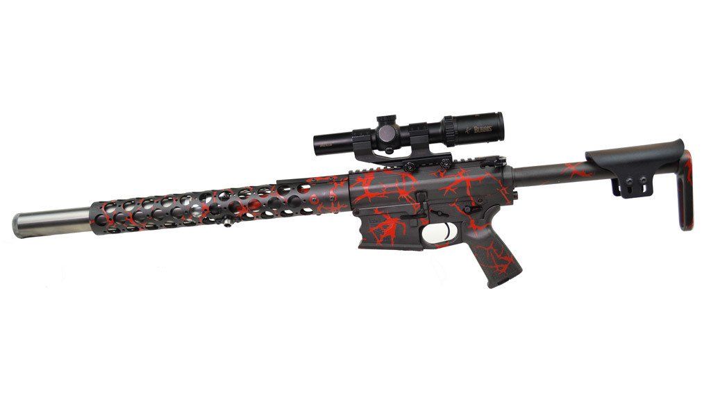 Red and black camo rifle with scope, stock, and long barrel.