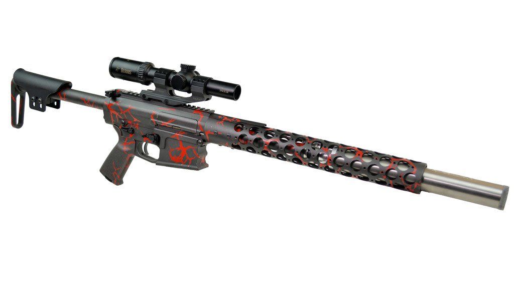 Black and red rifle with a scope, featuring a long barrel with patterned holes.