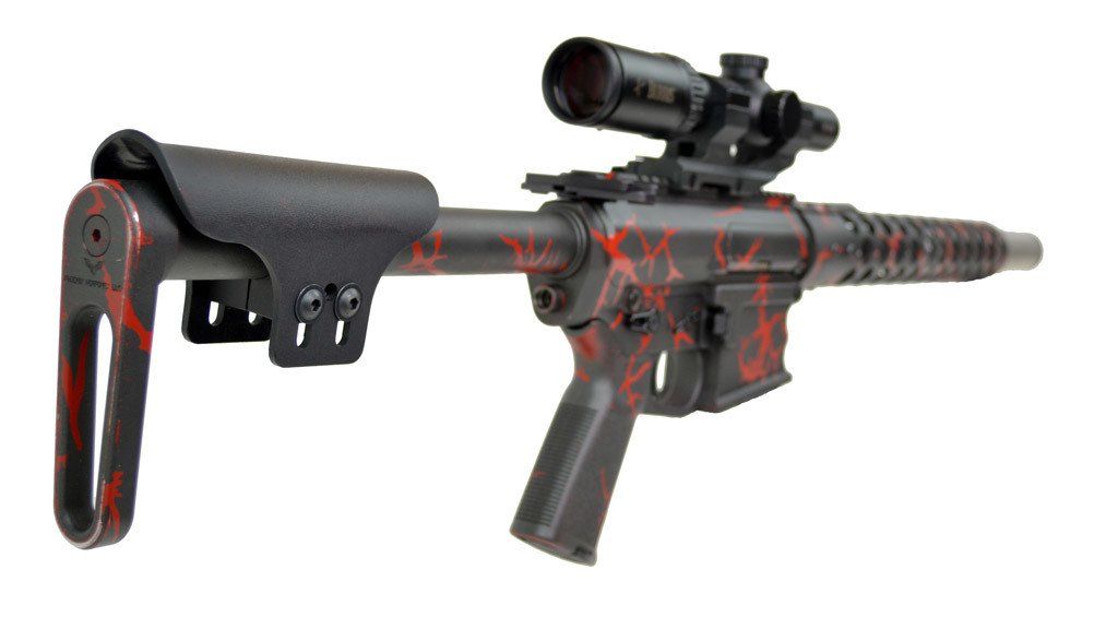 Red and black rifle with scope and adjustable stock against a white background.