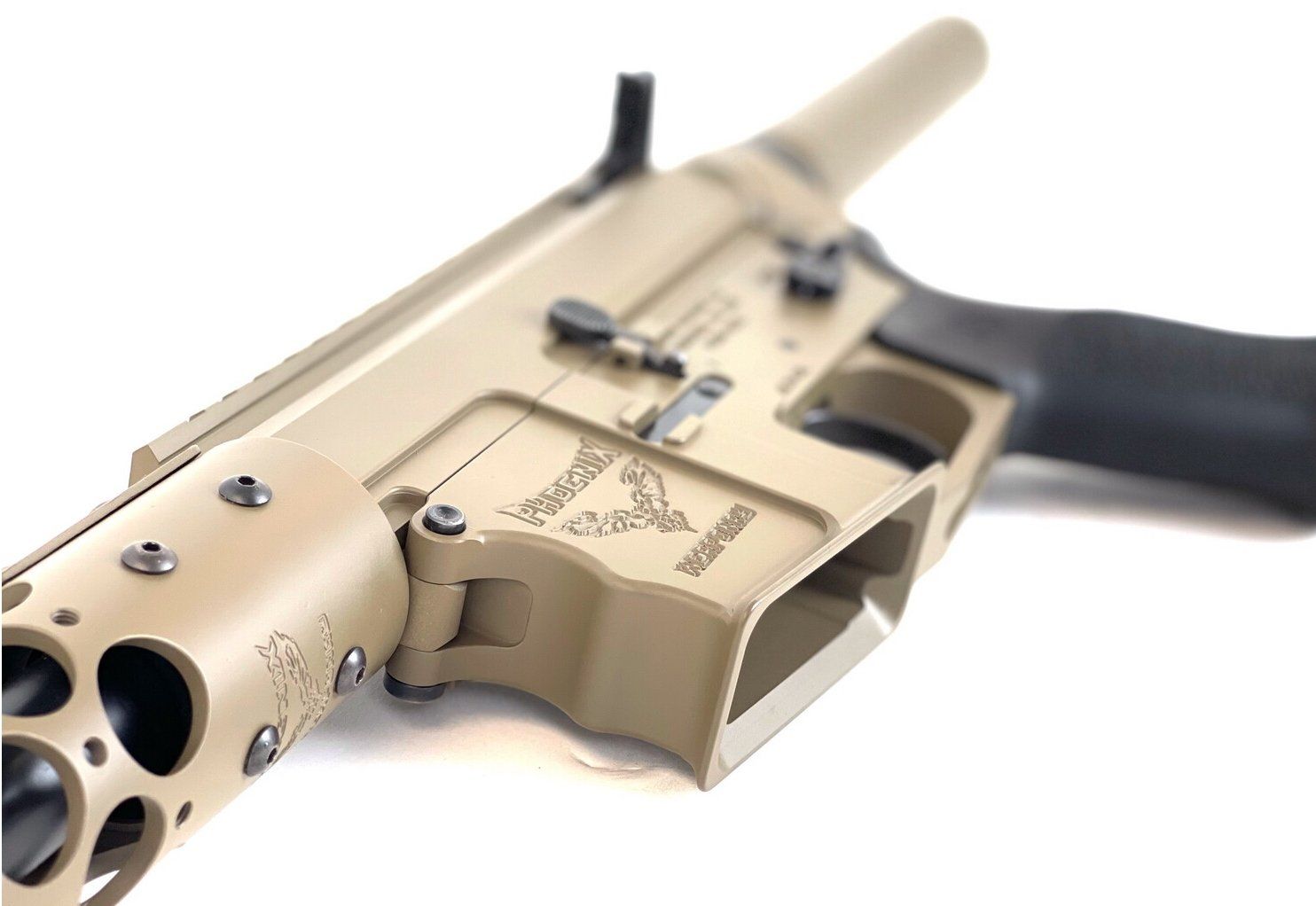 Tan and black rifle receiver with magazine well, barrel and stock.