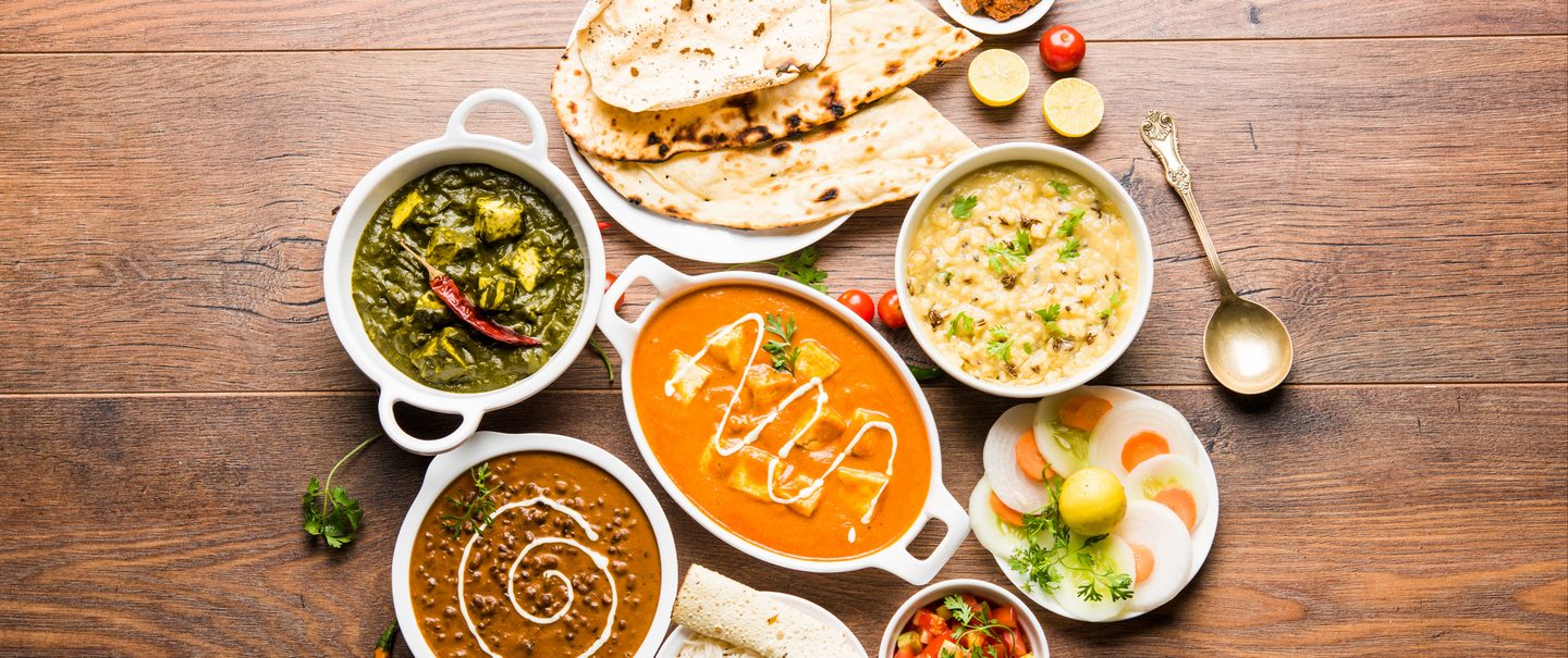 A table topped with plates of food and bowls of food.
