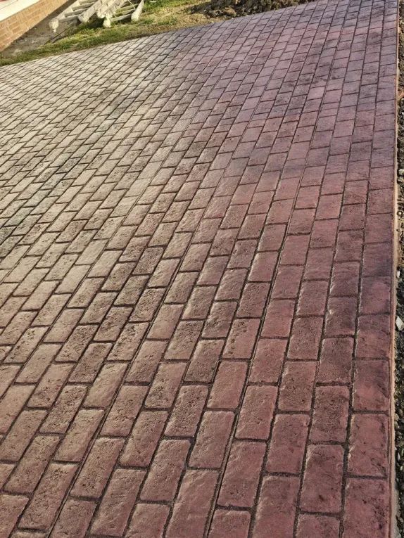 A close up of a brick walkway with a brick pattern