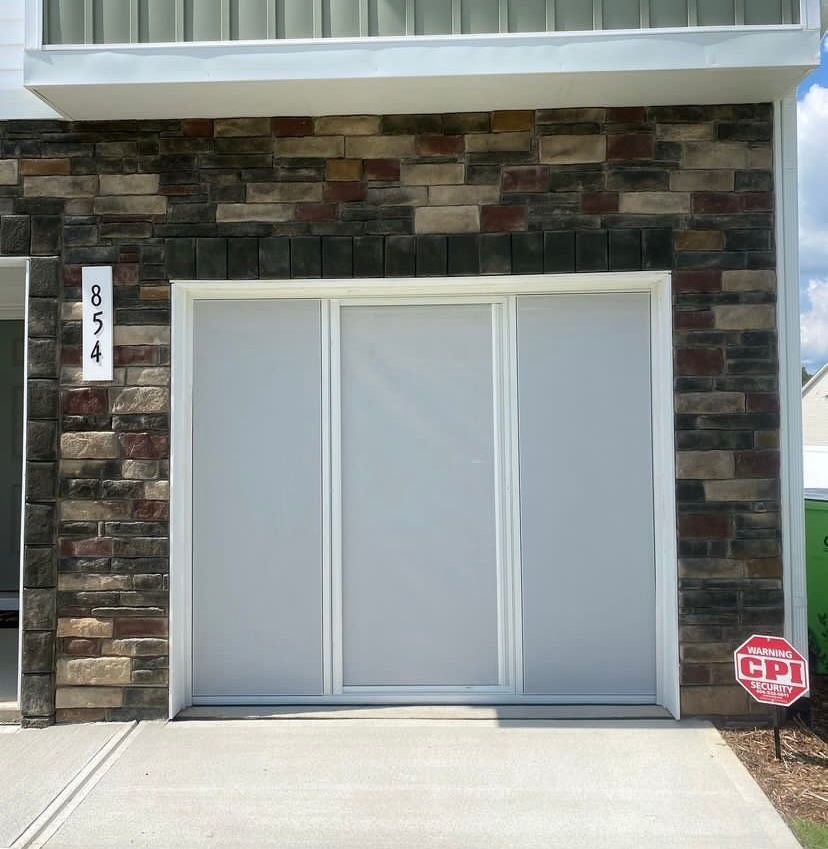 A white garage door with the number 3454 on it