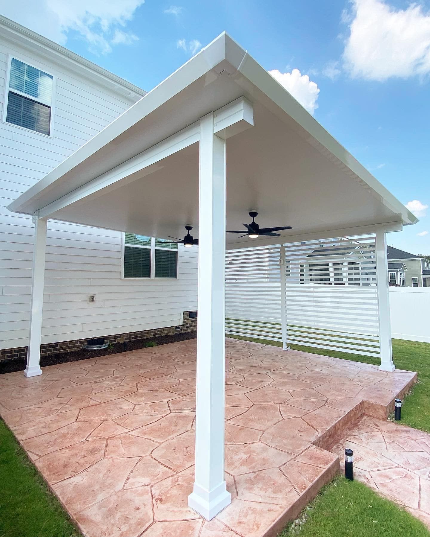 White patio cover with ceiling fan