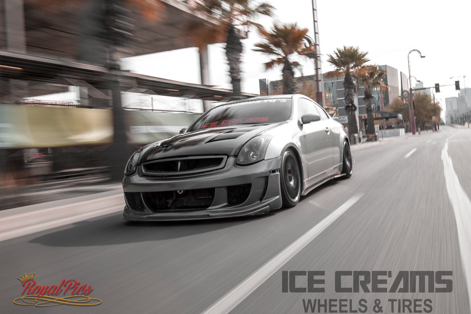 Lowered gray sports car speeding on a city street, with “ICE CREAMS WHEELS & TIRES” text