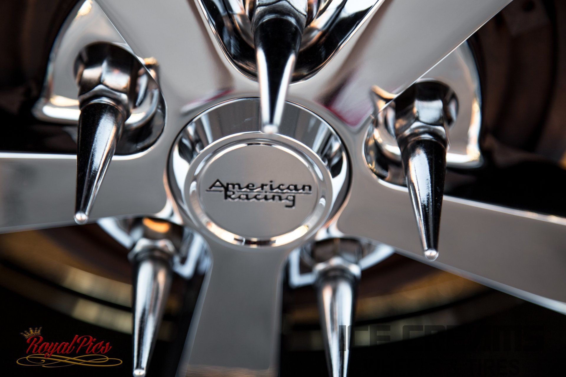 Close-up of chrome spiked car wheel hub with American Racing center cap