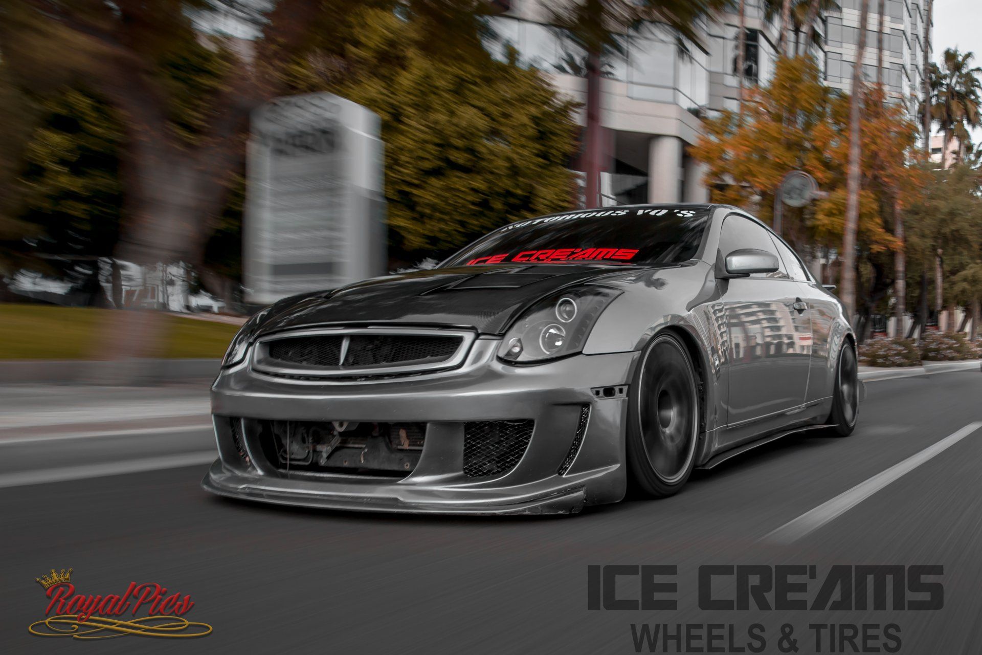 Silver custom sports car speeding on a blurred city street, with ICE CREAMS Wheels & Tires branding
