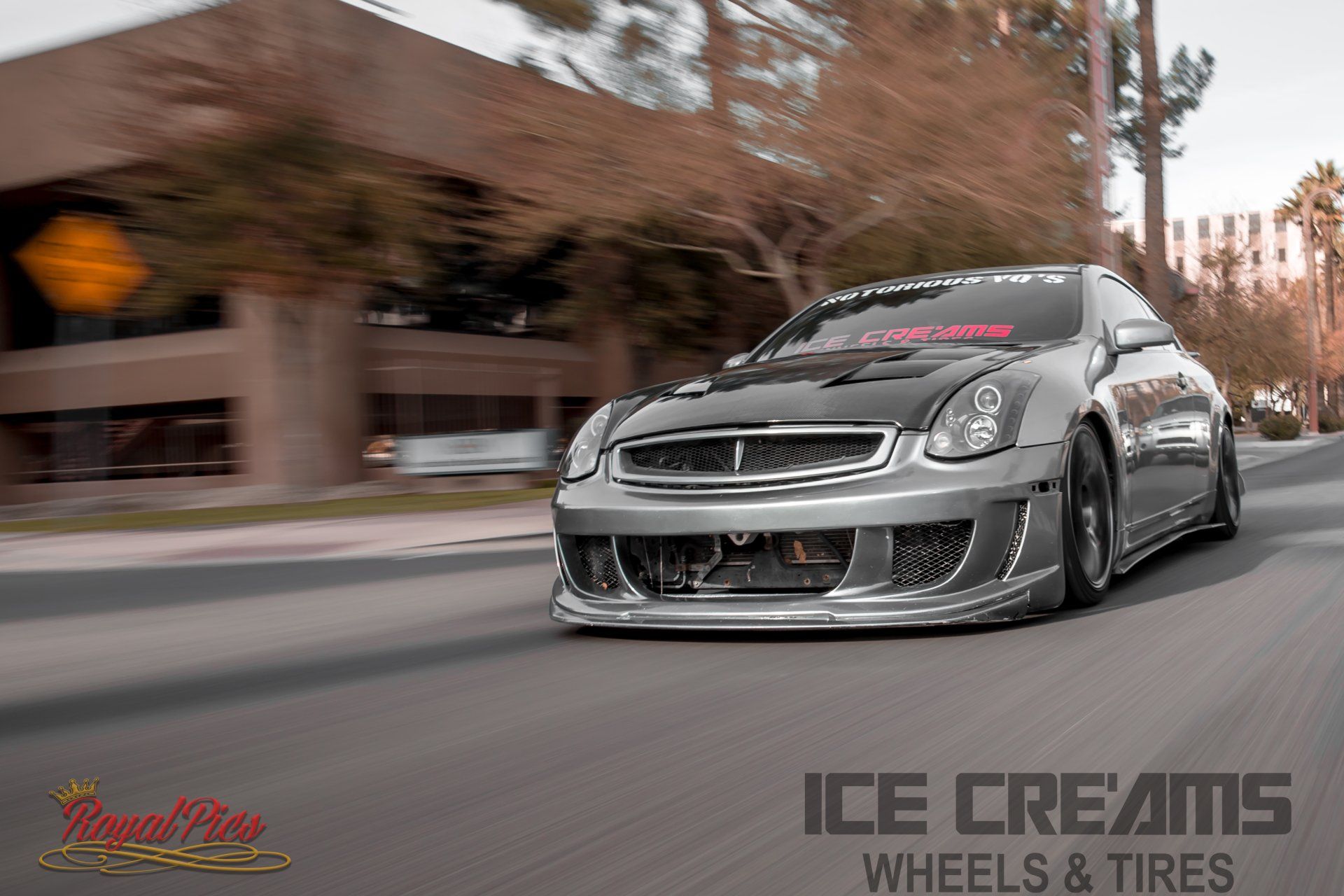 Low black sports car driving on a city street with motion blur, ICE CREAMS Wheels & Tires logo