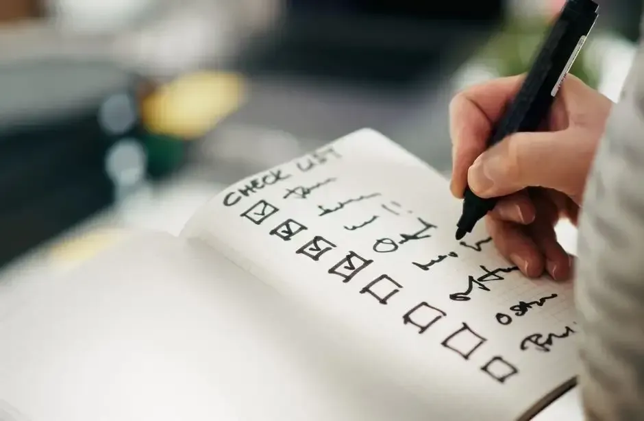 Checklist being marked in a notebook