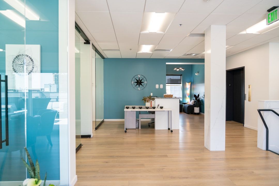 Modern office lobby with clean floors and glass partitions.