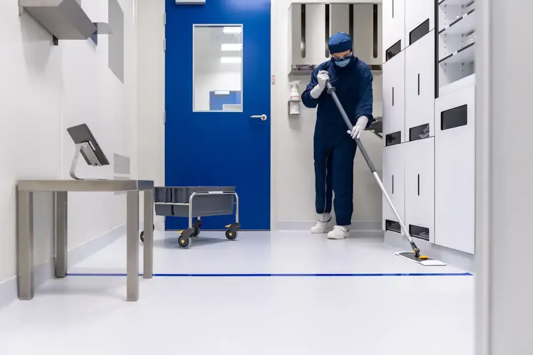 Uniformed commercial cleaning team working in a bright office space