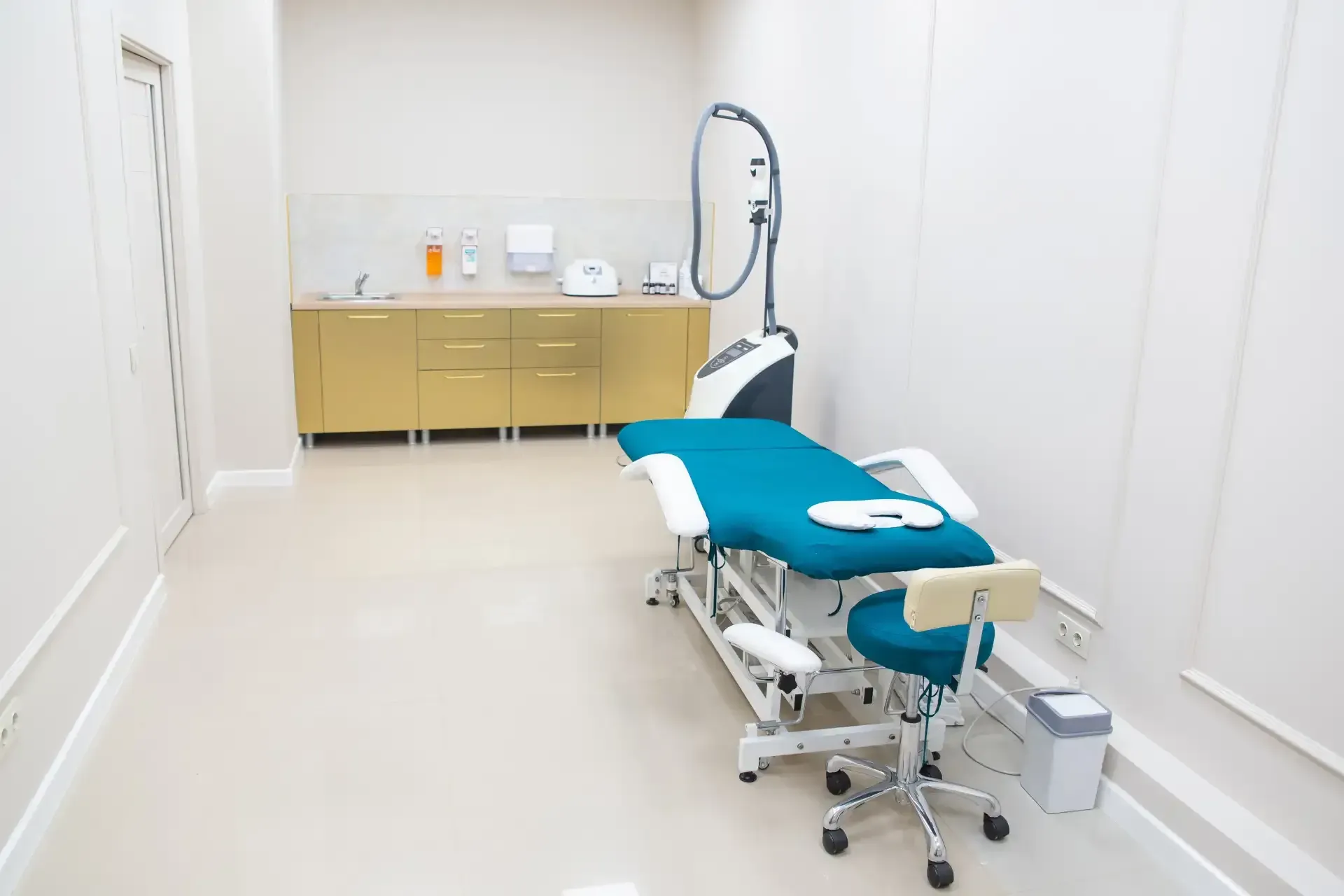 Sanitized medical clinic with a clean treatment room, exam table, and modern medical equipment.