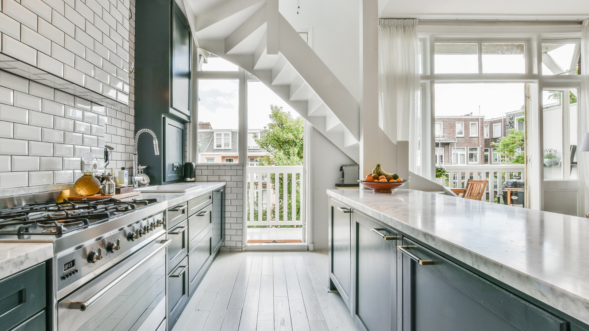 A kitchen with a staircase leading up to the second floor