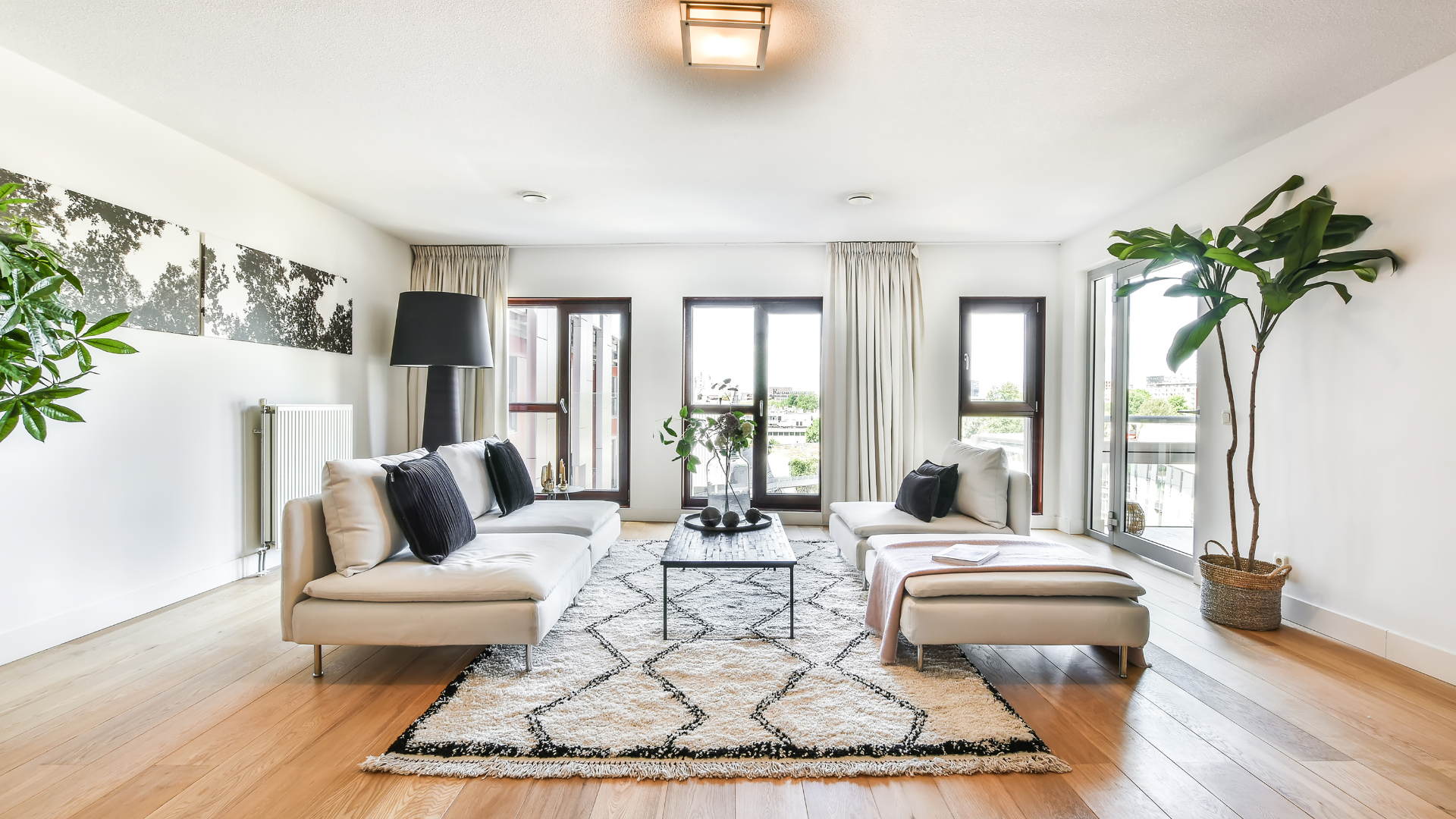 A living room with two couches , a coffee table , and a rug.