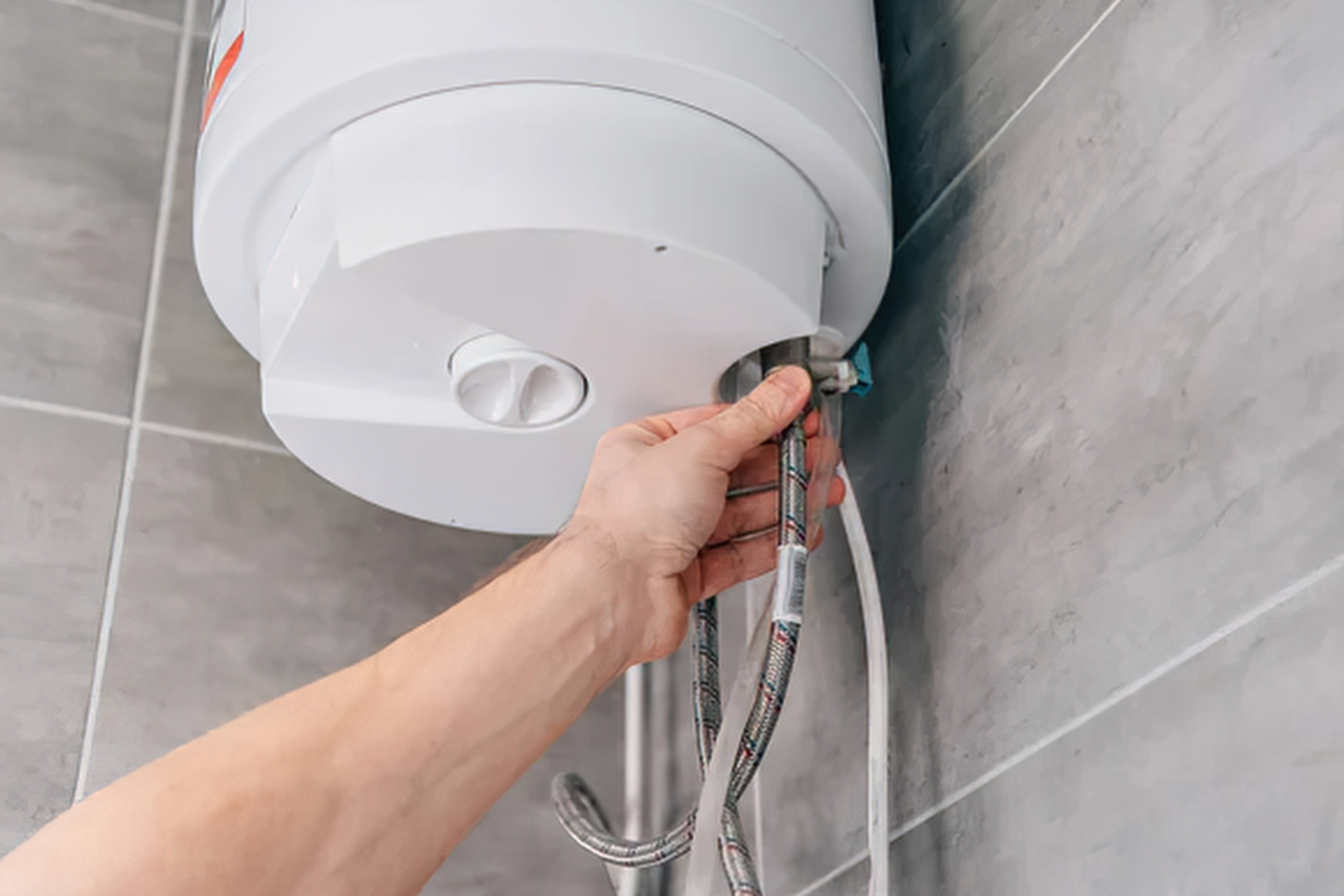 A white water heater with a label that says defender