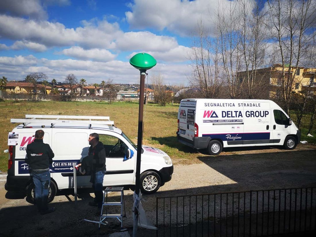 Furgoni bianchi della Delta Group parcheggiati a bordo strada