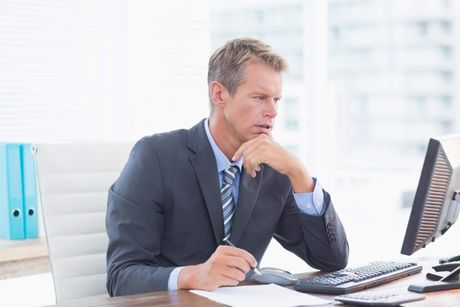 a man sitting at a desk in front of a computer