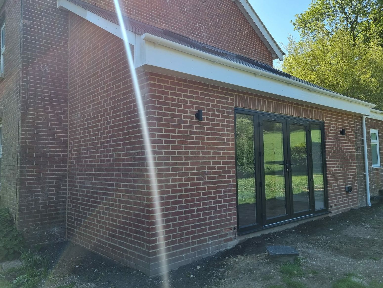 A brick house with a sliding glass door on the side of it.