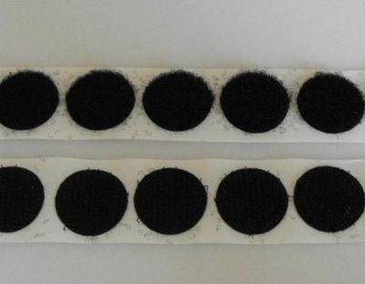 Two rolls of black circles on a white surface.