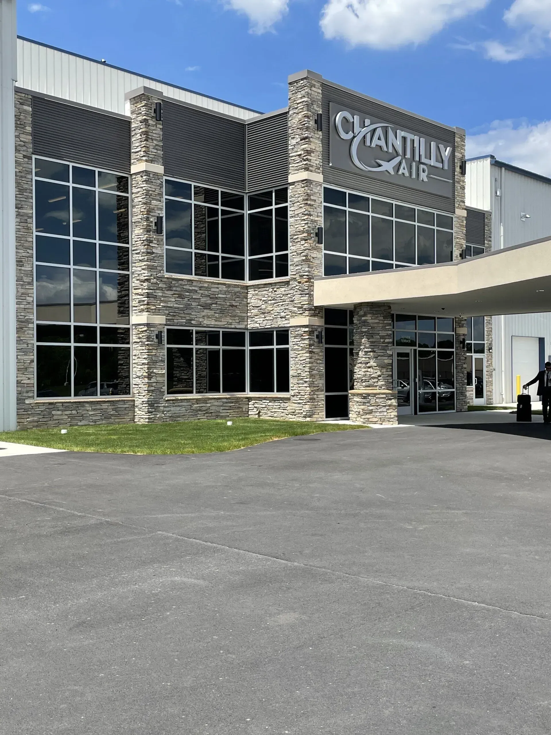 A large building with a sign that says ' quantilly hair ' on it
