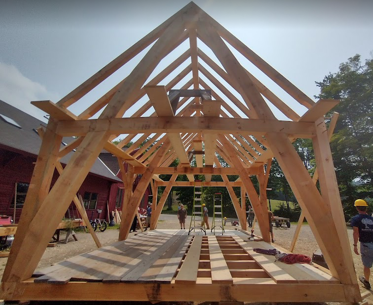 A 16'x24' Cruck frame set up outside the Heartwood shop