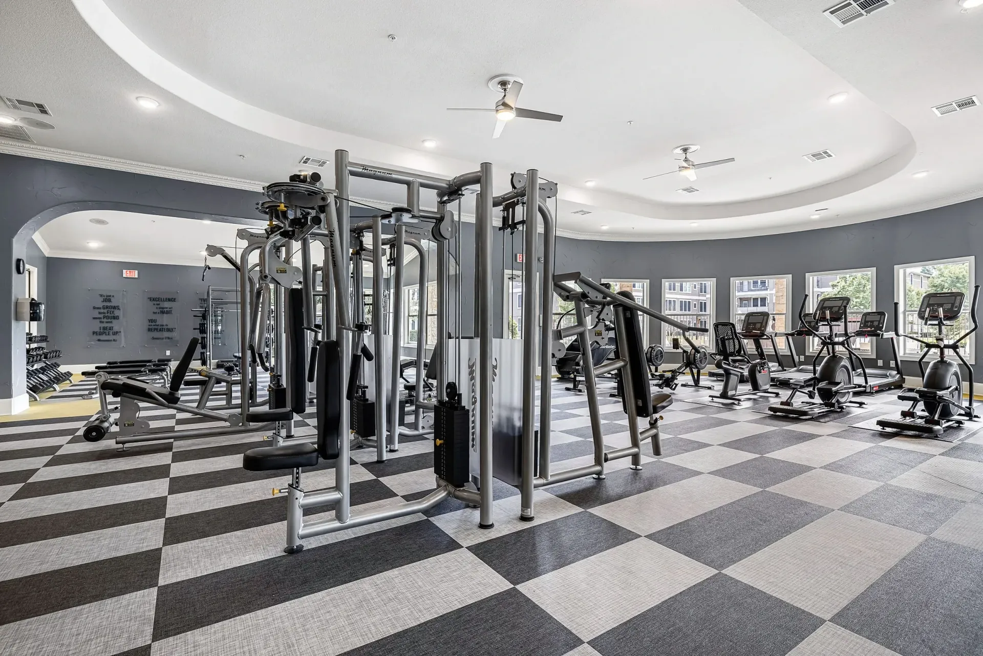 Gym with weight machines, cardio equipment, and free weights.