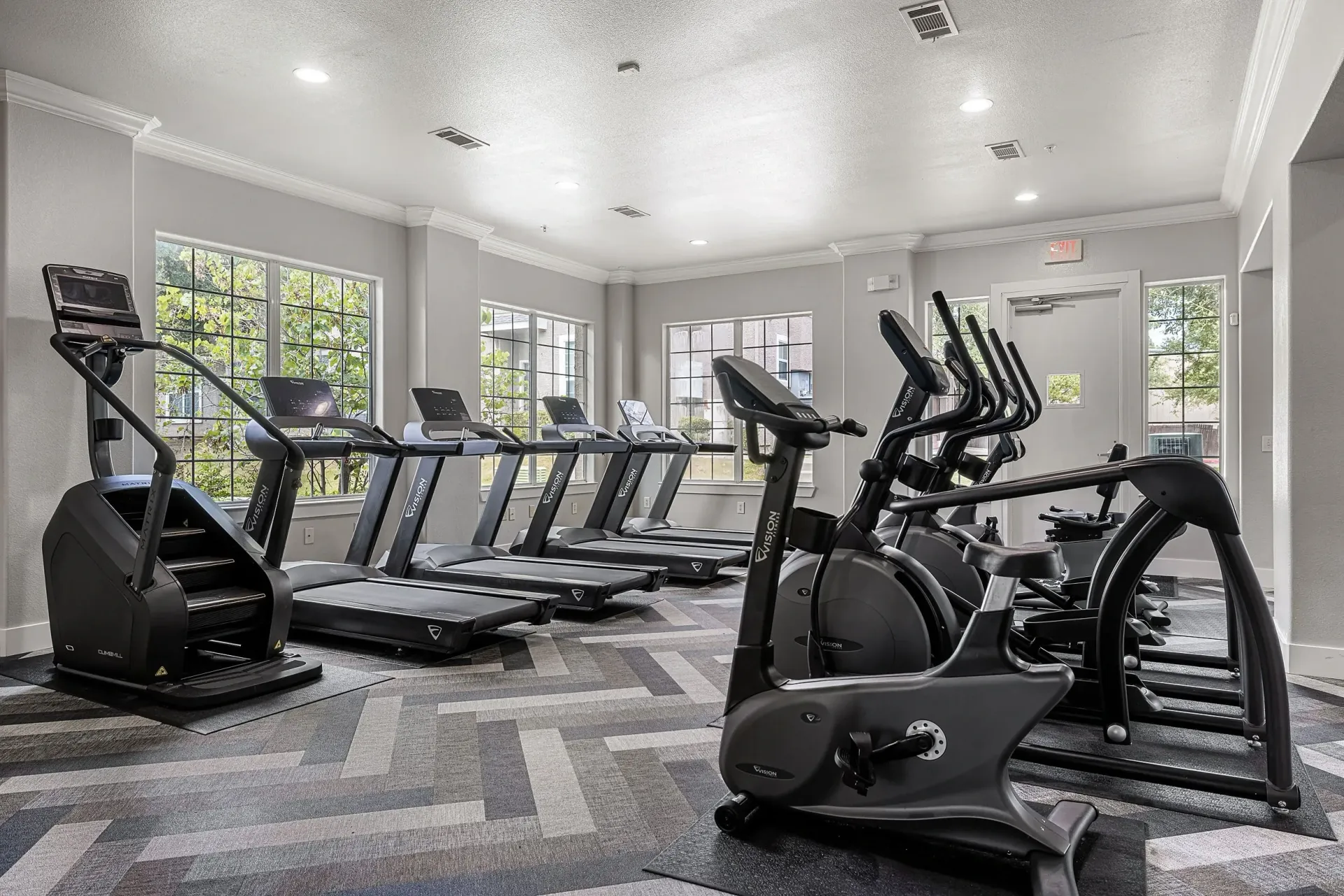Fitness center with treadmills, stair climber, and elliptical machines.