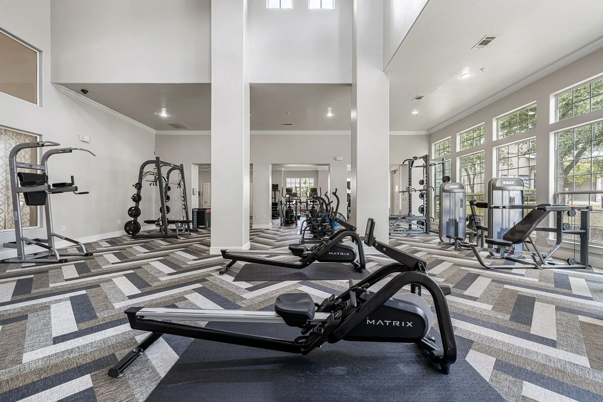 Fully equipped fitness center with cardio machines, weight machines, and free weights.