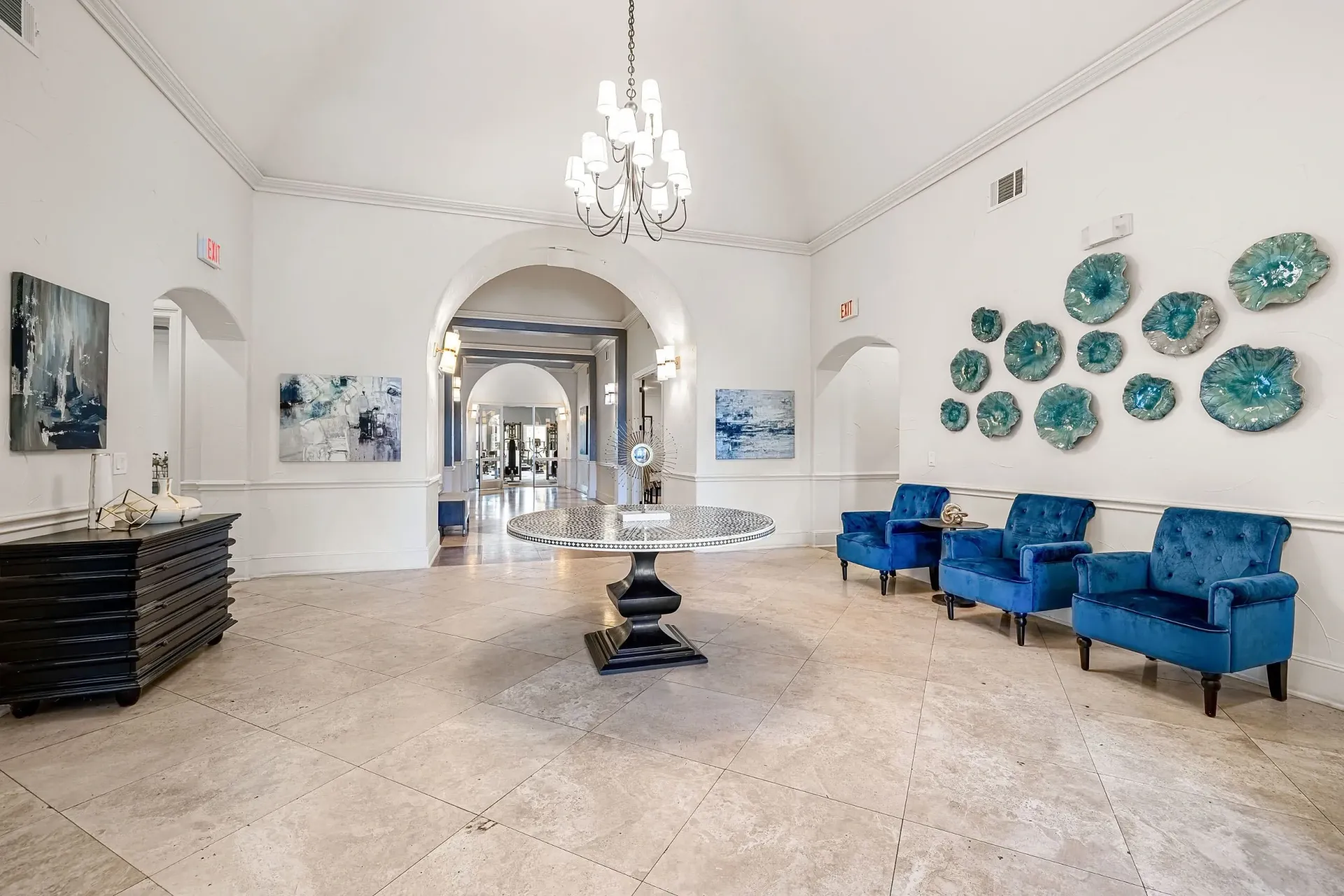 Luxurious apartment building lobby with comfortable seating and modern art.